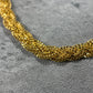 Close up picture of our elegant 22ct Yellow Gold Hallmarked Chotla Necklace—a true testament to craftsmanship. Its intricate gold braided-chain design exudes sophistication, complemented by a highly polished finish. Length: 18" (45.7cm). Available in various lengths and comes with packaging. Elevate your style with this finely crafted gold necklace today.