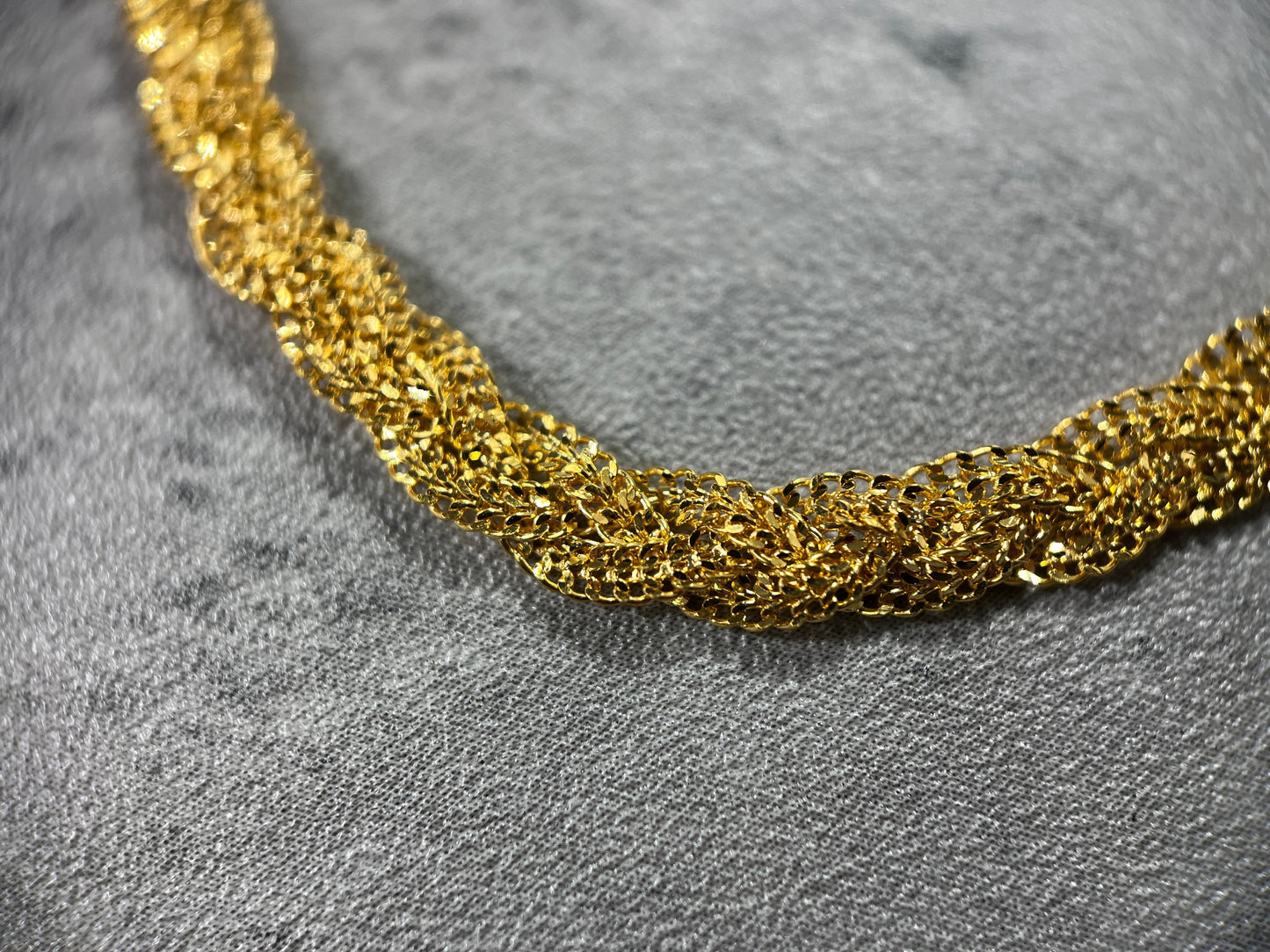 Close up picture of our elegant 22ct Yellow Gold Hallmarked Chotla Necklace—a true testament to craftsmanship. Its intricate gold braided-chain design exudes sophistication, complemented by a highly polished finish. Length: 18" (45.7cm). Available in various lengths and comes with packaging. Elevate your style with this finely crafted gold necklace today.