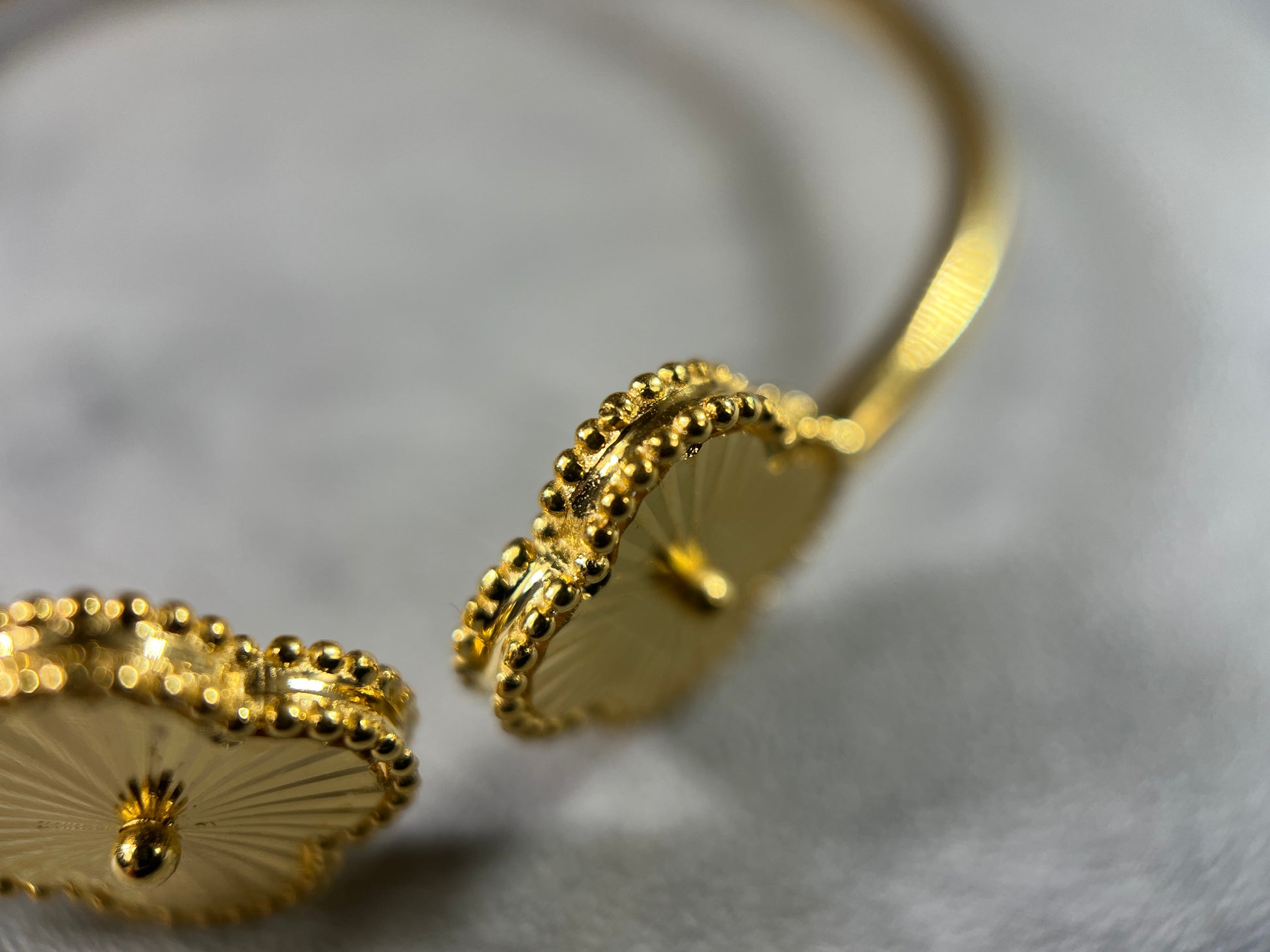 Exquisite 22ct Yellow Gold Hallmarked Bracelet—a symbol of timeless elegance. Crafted with intricate flower detailing, this highly polished piece radiates sophistication. With a cuff diameter of 6cm and two delicate clovers, it adds a touch of grace to any ensemble. Available in various sizes, please contact us for a personalized quote. Each bracelet comes beautifully packaged, making it a perfect gift choice. Embrace the allure of this finely crafted gold bracelet and elevate your style!