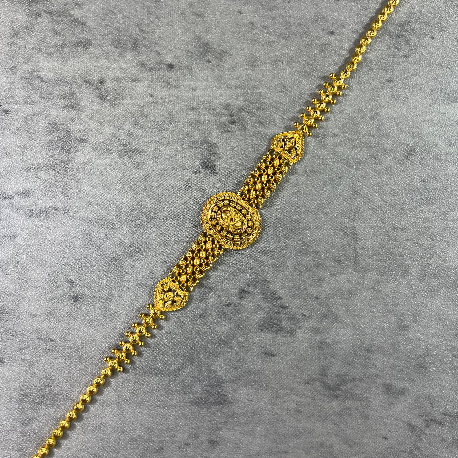 22ct Yellow Gold Hallmarked Bracelet—a pinnacle of elegance. Its highly polished, flat gold design with delicate flower detailing exudes sophistication. Measuring 7.5 inches (19cm) in length, this bracelet offers a comfortable fit. Delivered in exquisite gift packaging, it's the perfect choice for a touch of luxury or a thoughtful present. Elevate your style with this timeless and beautifully crafted gold bracelet today!