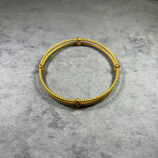 our stunning 22ct Yellow Gold Hallmarked Double Joined Bangle—an exquisite blend of craftsmanship. Its intricately hand-carved design and highly polished finish exude sophistication. With a comfortable 6cm diameter and a sleek 1.8cm width, it complements any outfit. Each bangle comes with elegant gift packaging, making it a perfect choice for yourself or a loved one. Elevate your style with this beautifully crafted gold bangle—a true symbol of timeless elegance.