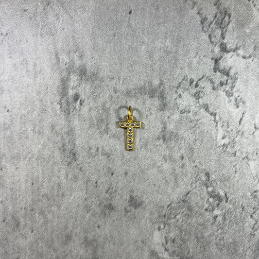 Handcrafted stone-set cross pendant, embodying intricate detail and timeless elegance.