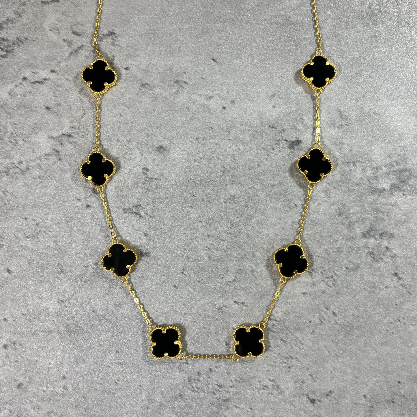 A 8 clover onyx necklace in 22ct yellow gold hallmarked. The design of the onyx is of a 4 petal flower, and the clasp of the bracelet is a lobster clasp. Length of necklace is 18 inches. The item is ready for purchase, and is perfect as a treat for oneself, a gift for a family or friend! This necklace is a statement piece, can be worn on its own or stacked alongside other necklaces. 