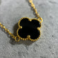 Close up picture of the onyx clover. A 8 clover onyx necklace in 22ct yellow gold hallmarked. The design of the onyx is of a 4 petal flower, and the clasp of the bracelet is a lobster clasp. Length of necklace is 18 inches. The item is ready for purchase, and is perfect as a treat for oneself, a gift for a family or friend! This necklace is a statement piece, can be worn on its own or stacked alongside other necklaces. 